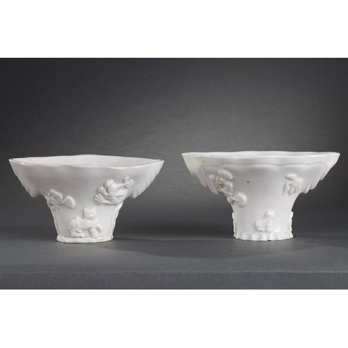 Pair of "blanc de Chine" rhinoceros horn shaped cups with animals decoration like: tiger dragon deer or crane